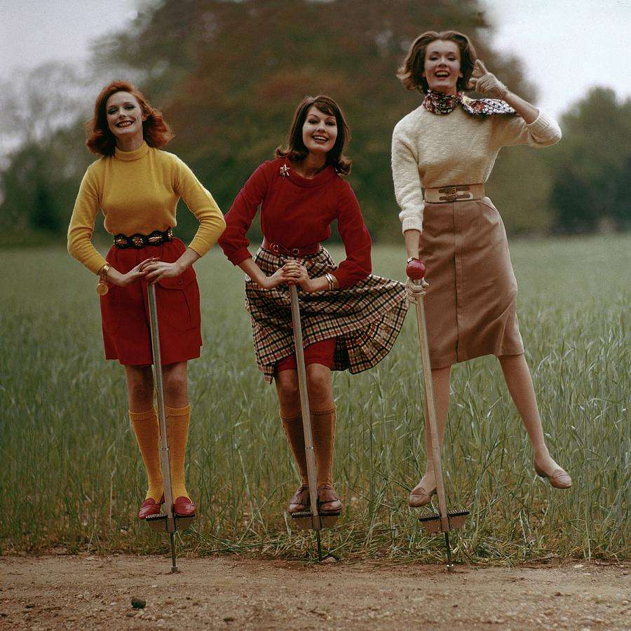 three women on pogo sticks