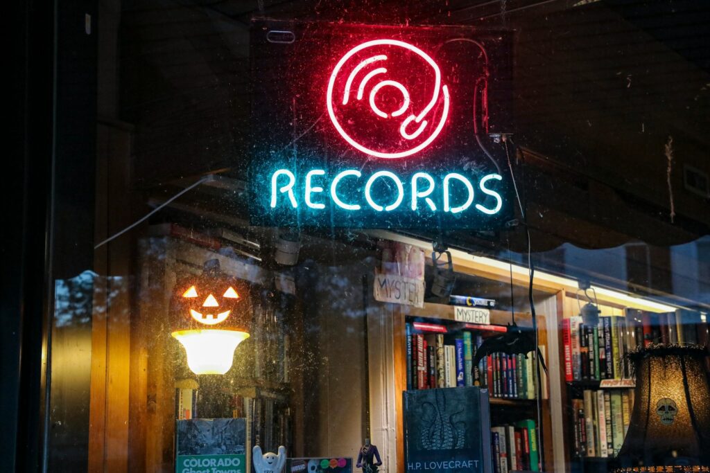 a record shop with a neon sign above it