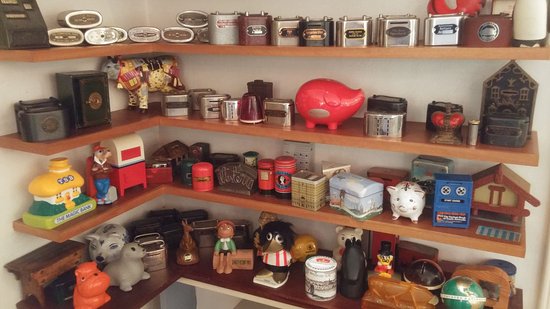 A collection of money boxes on a shelf