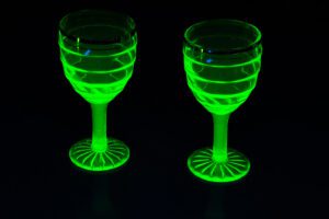 Two wine glasses with uranium glass