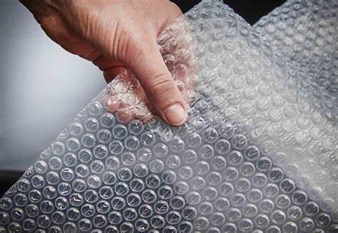 A hand holding a piece of bubble wrap