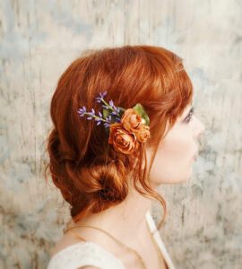 red haired woman with intricate hairclip on