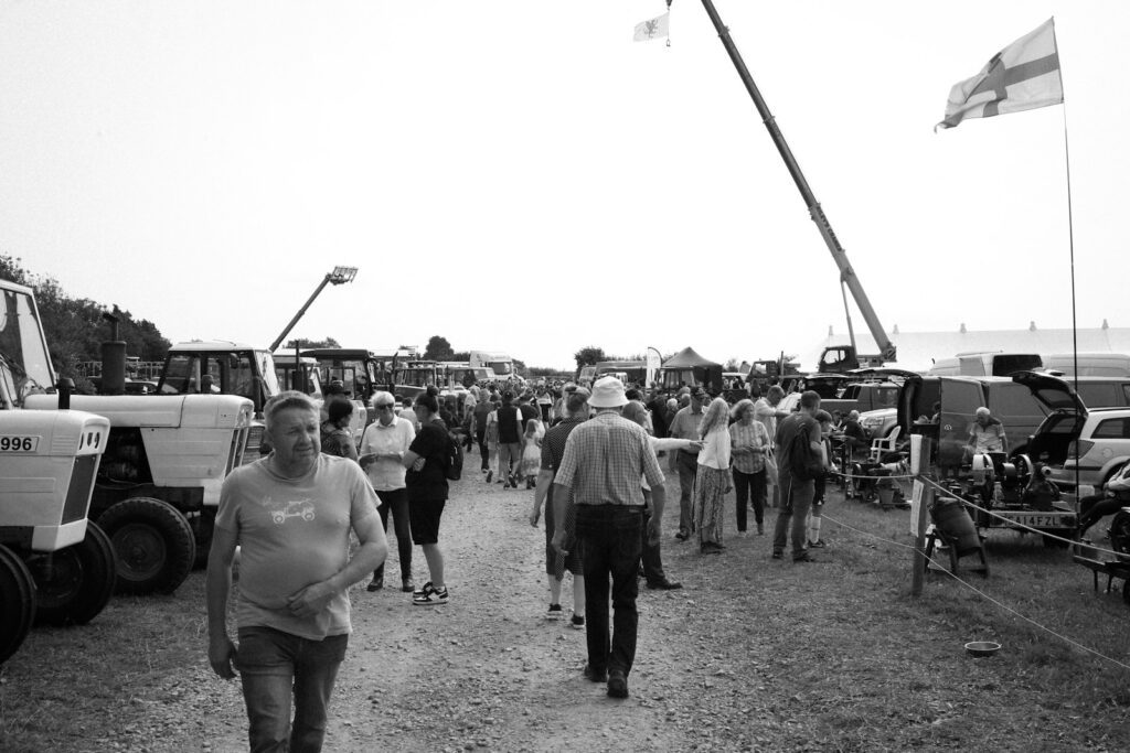 A group of people walking down a dirt road