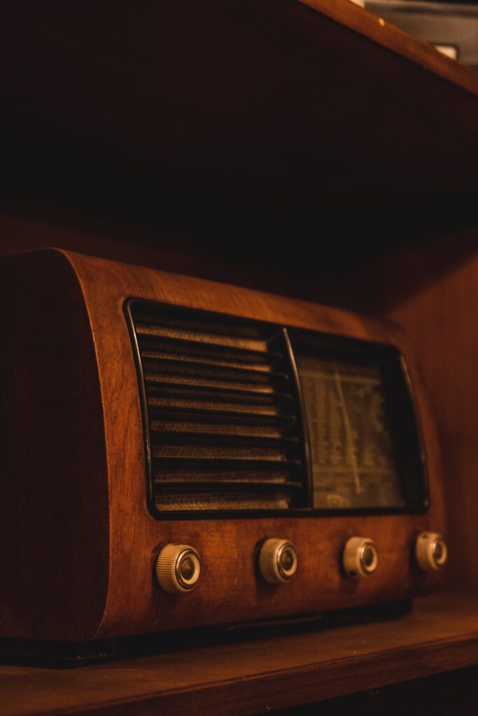 a radio sitting on top of a wooden shelf